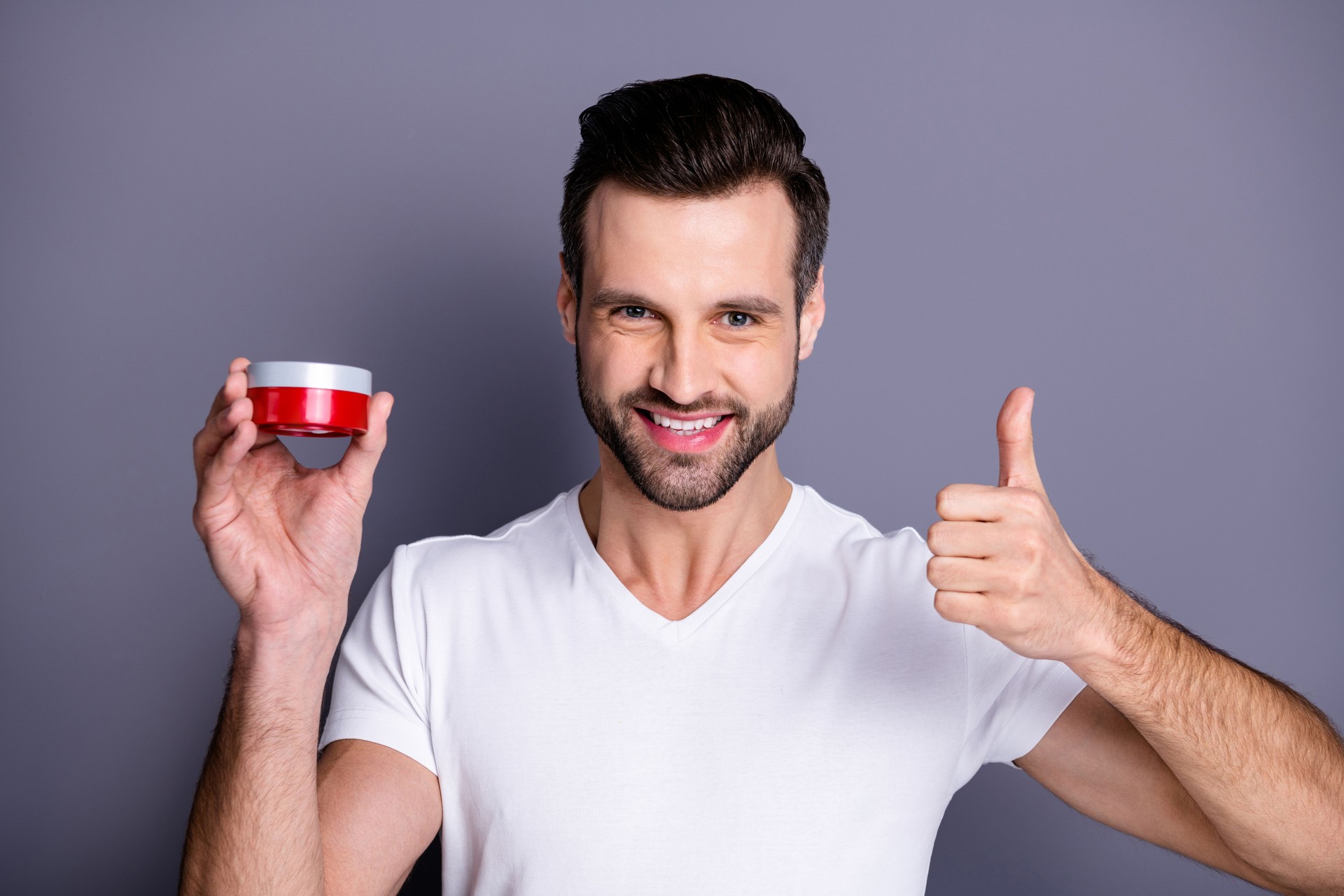 Close up photo amazing he him his macho perfect ideal appearance thumb up symbol advising buy buyer hand arm novelty styling gel wax hairstyle wear casual white t-shirt isolated grey background